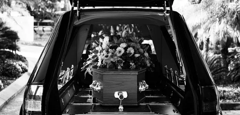 grayscale photo of car with flowers