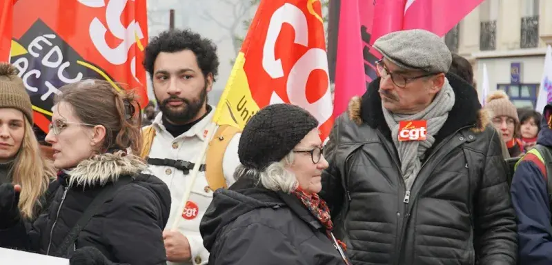 A large group of people holding a banner