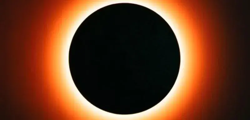 Dramatic view of a total solar eclipse showcasing a fiery ring illuminating the dark circle.