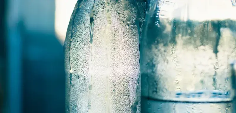 clear glass bottle with water