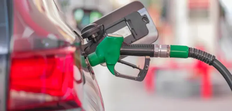 a gas pump is connected to a car at a gas station