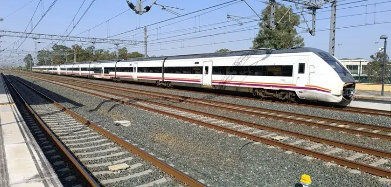 High-speed train at Jerez de la Frontera railway station, sunny day.