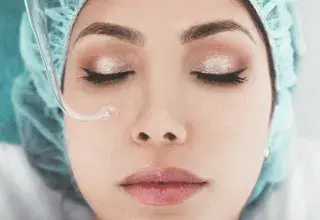 woman with teal hospital head gown