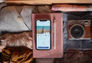 an open suitcase with a cell phone and other items