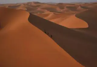 Stunning view of sand dunes under a clear blue sky in Algeria.