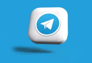 a blue and white square button with a paper airplane on it