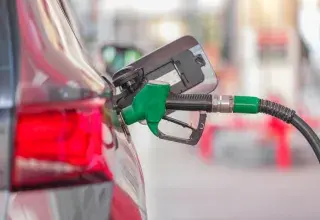 a gas pump is connected to a car at a gas station