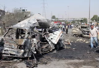 Véhicules déchiquetés par l'explosion d'une bombe à Damas. (Xinhua)